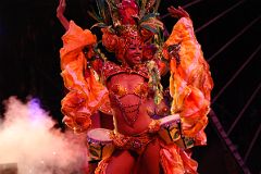 
Mulatta dancers wearing next to nothing or sequined costumes and giant plumed headdresses parade and perform to the whole gamut of Latin-American music at the Tropicana in Havana.
